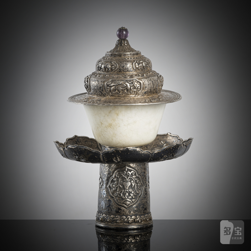 A jade bowl with stand and cover in silver with animals and floral motifs in relief